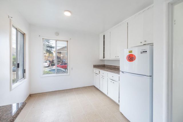 a kitchen with cabinets and white appliances