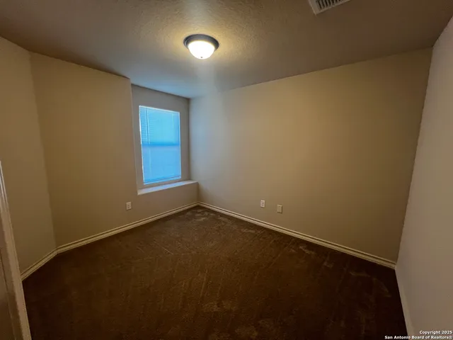 an empty room with a empty space and a window