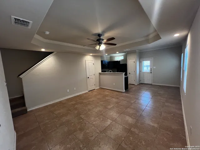 an empty room with a empty space and a ceiling fan