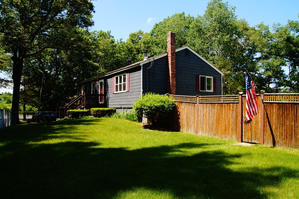 5 Harvard Road Billerica, MA 01821 - Photo 4 of 29 a backyard of a house with plants and large trees
