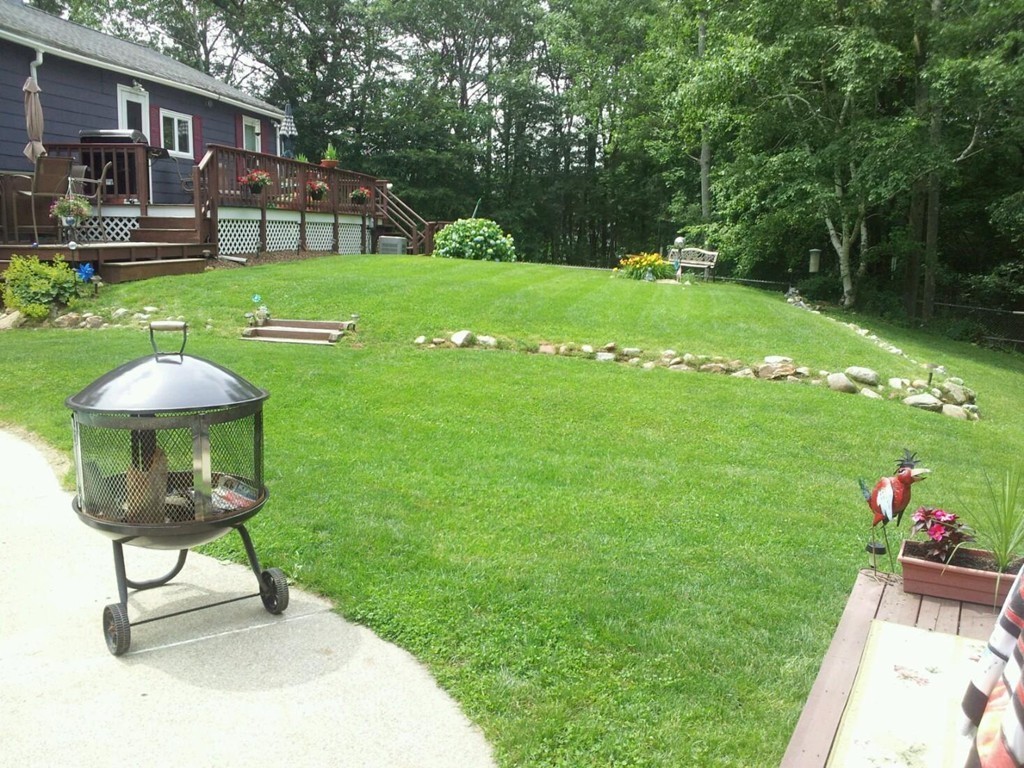 5 Harvard Road Billerica, MA 01821 - Photo 7 of 29 a backyard of a house with table and chairs