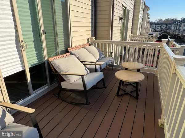 a balcony with table and chairs