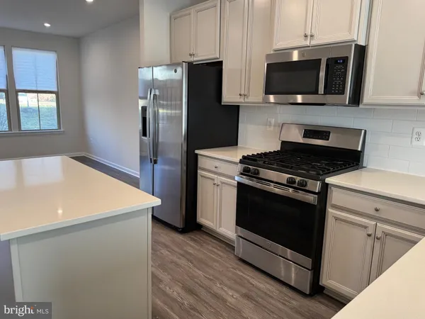 a kitchen with cabinets and steel stainless steel appliances