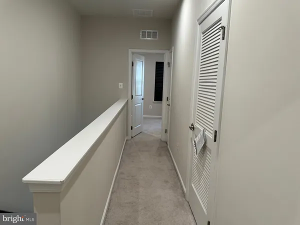 a view of a hallway with a white walls