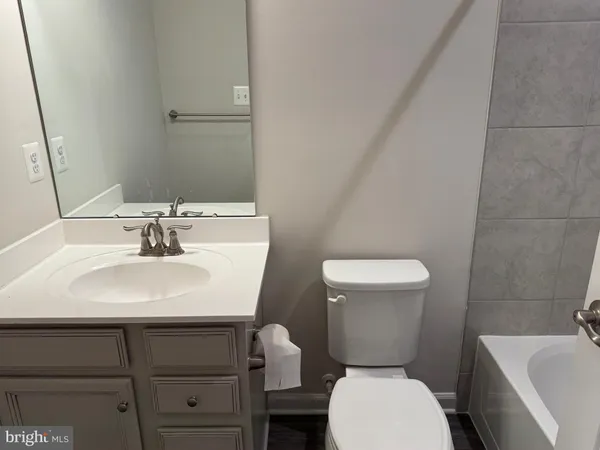 a bathroom with a sink a toilet a mirror and vanity