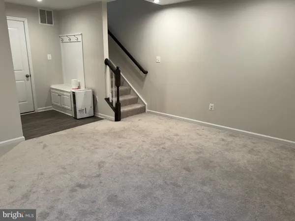 a view of an empty room with stairs