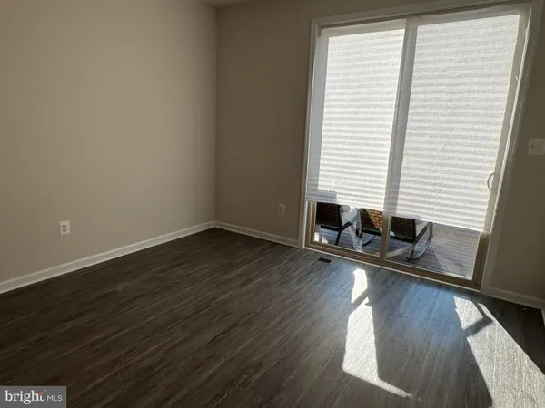 a room with wooden floor and a window