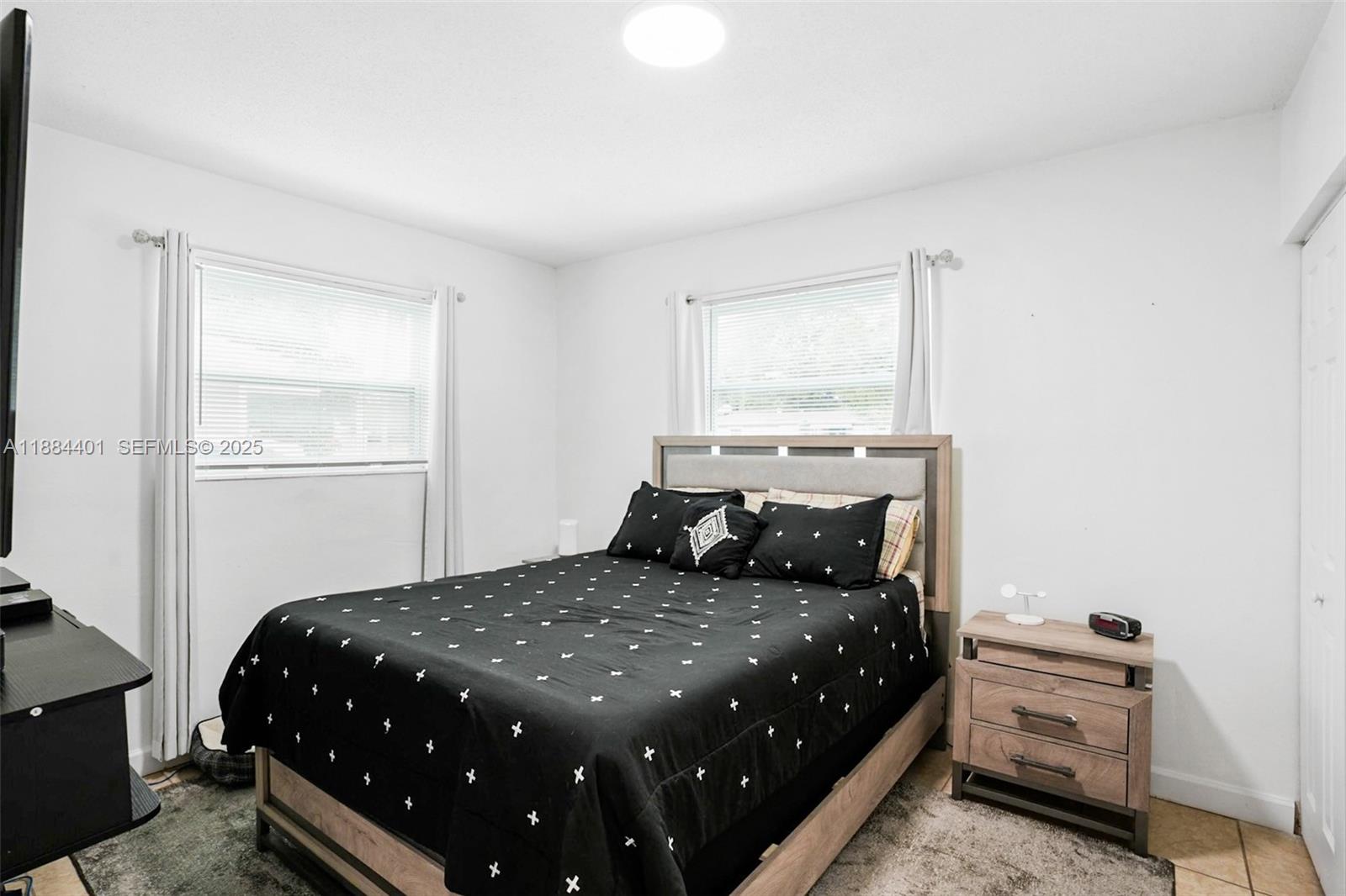 621 Southwest 50th Terrace Margate, FL 33068 - Photo 7 of 18 a bedroom with a large bed and a window