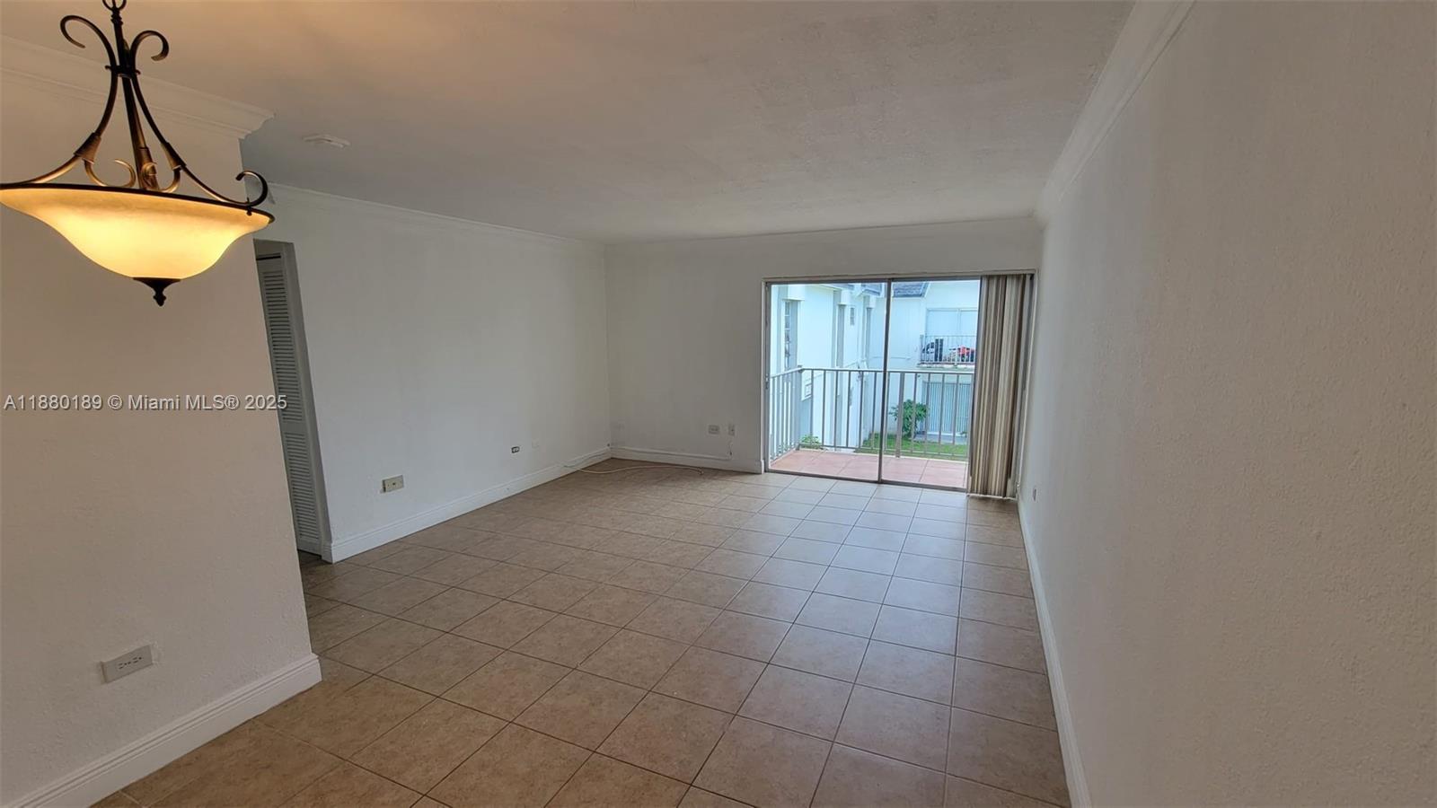 7232 Southwest 94th Place, Unit E7 Miami, FL 33173 - Photo 3 of 10 a view of an empty room with a window