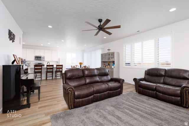 540 Lefty Lane Tooele, UT 84074 - Photo 12 of 48 Living area with light wood-type flooring, a ceiling fan, recessed lighting, and a textured ceiling