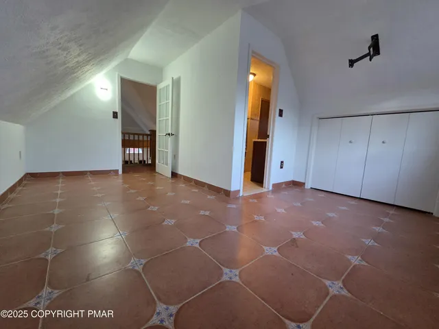 a view of hallway with a bathroom