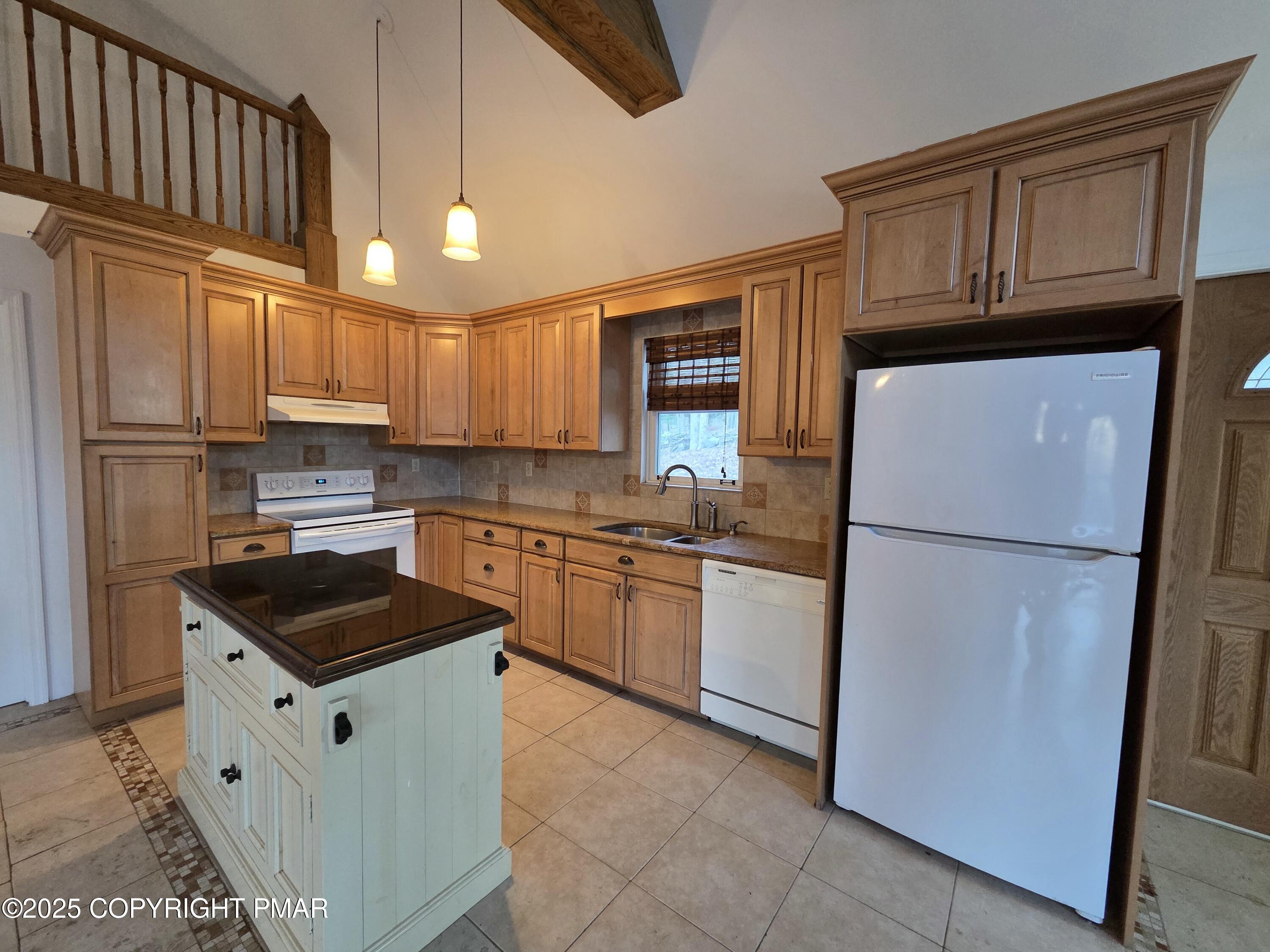 107 Berkshire Court Bushkill, PA 18324 - Photo 6 of 16 a kitchen with granite countertop a refrigerator stove top oven a sink and dishwasher