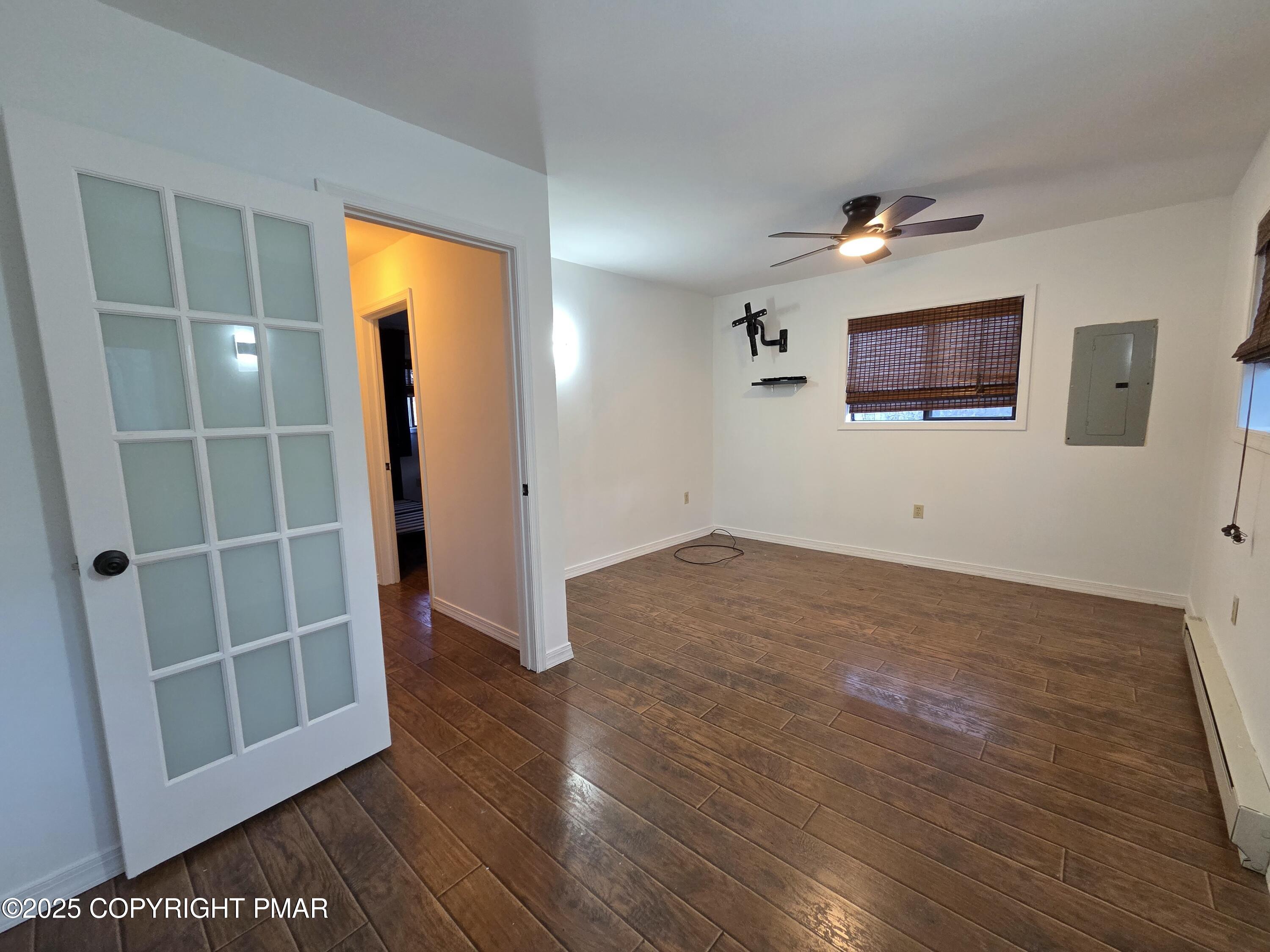 107 Berkshire Court Bushkill, PA 18324 - Photo 8 of 16 an empty room with wooden floor and a window