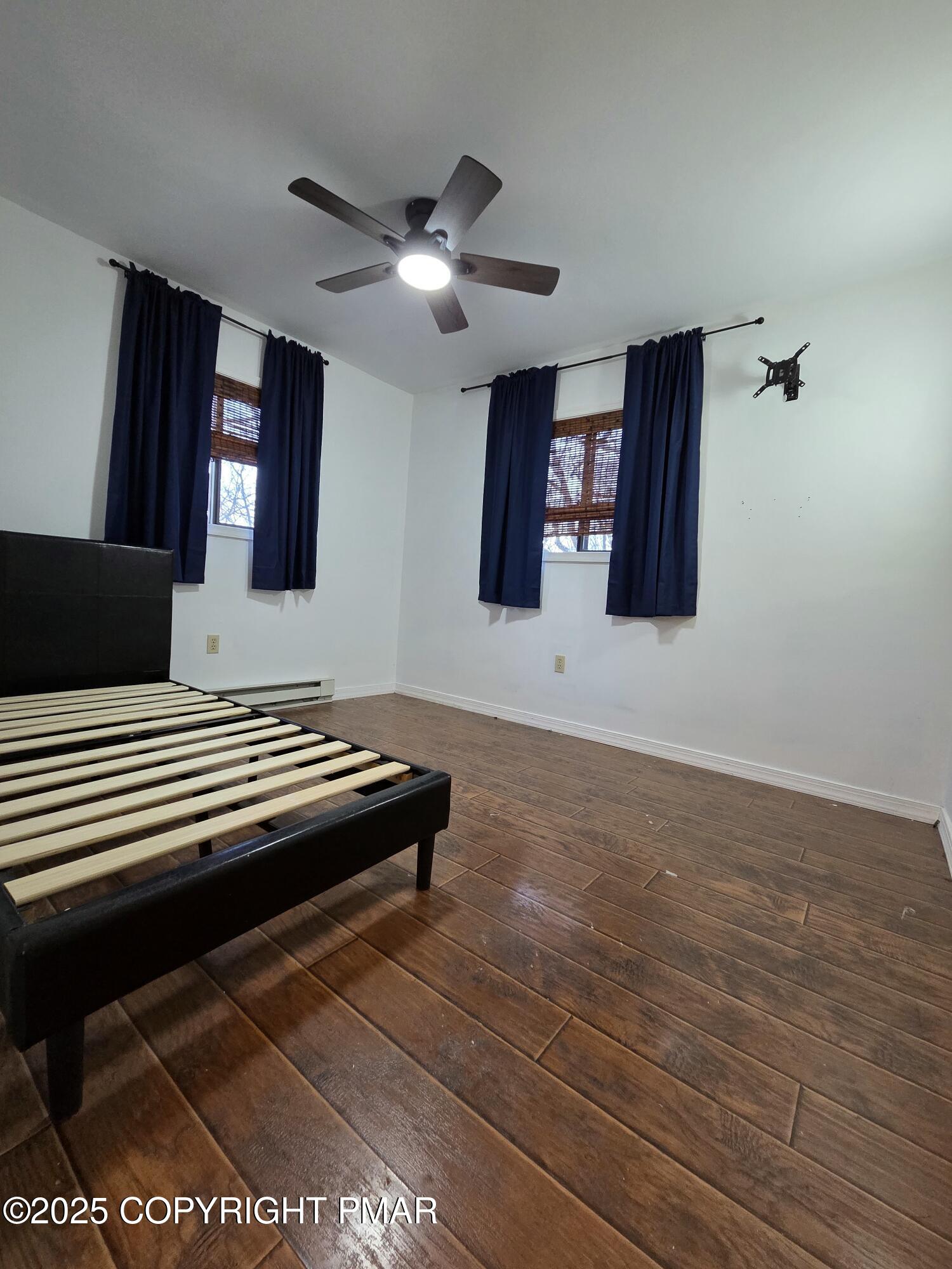 107 Berkshire Court Bushkill, PA 18324 - Photo 10 of 16 a bedroom with a bed and wooden floor