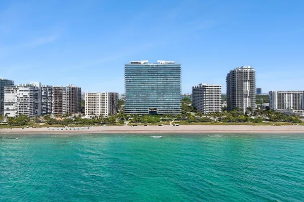 a view of a city with tall buildings and a big yard