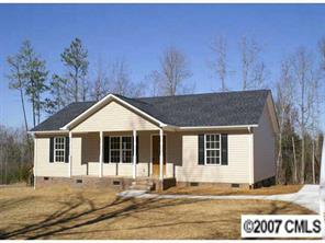 374 Sutton Spring Road York, SC 29745 - Photo 1 of 8 a house with trees in the background