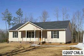 374 Sutton Spring Road York, SC 29745 - Photo 4 of 8 a house with trees in the background