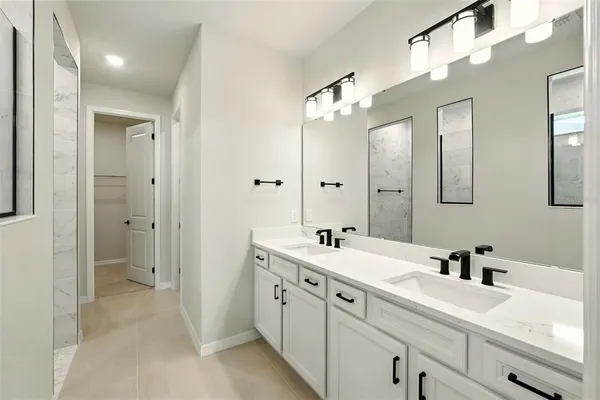 a spacious bathroom with a double vanity sink mirror and