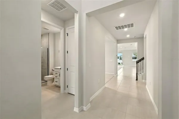 a view of a hallway with a livingroom and a bathroom