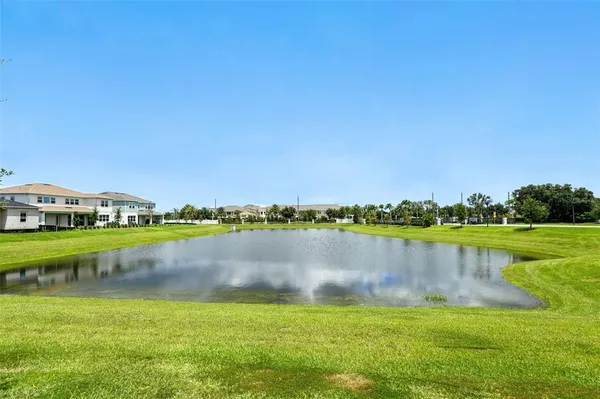 a view of a lake with houses in the background