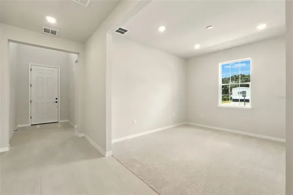 an empty room with windows and closet