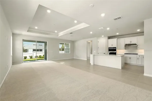 a view of kitchen with kitchen island and stainless steel appliances
