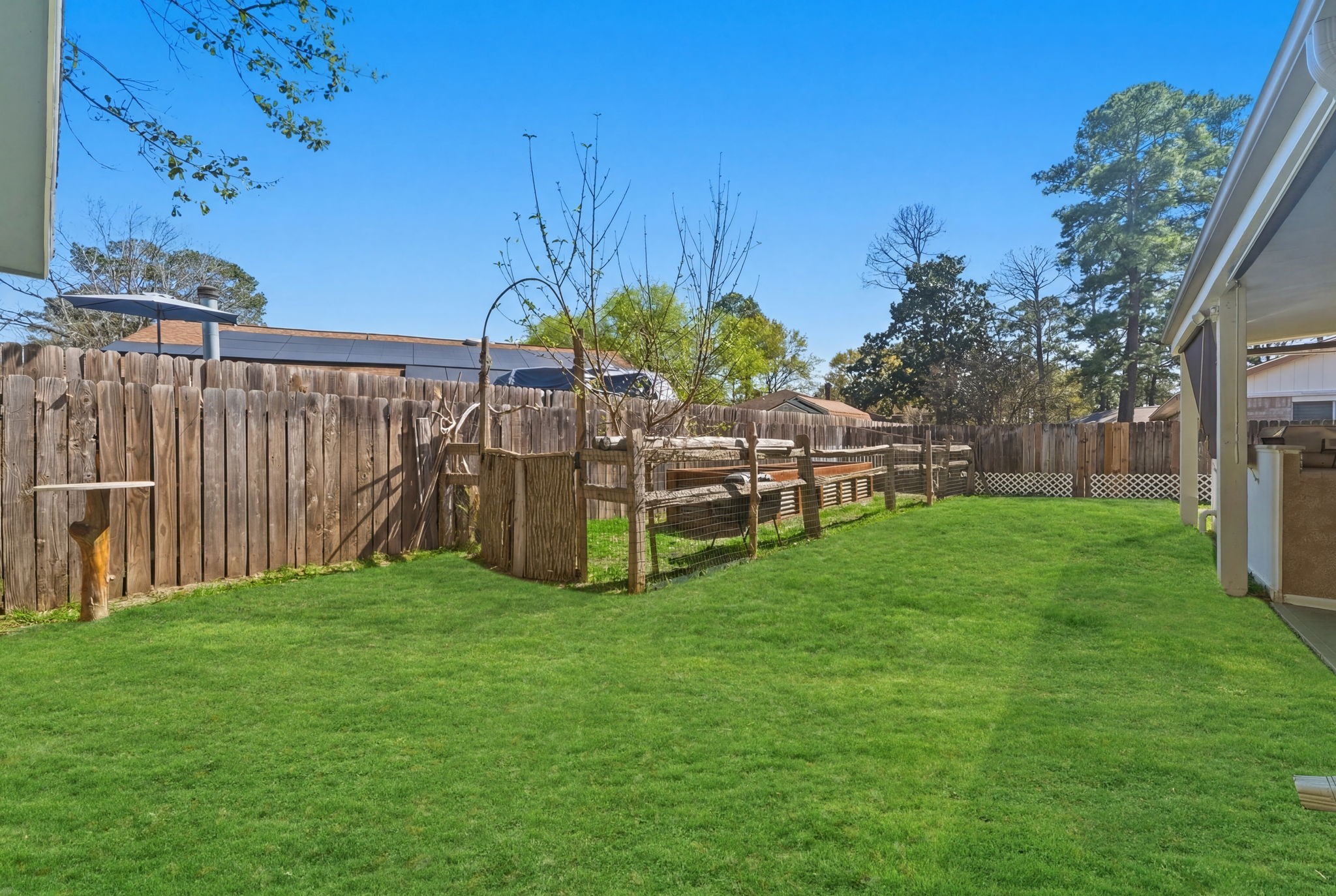 21514 Slippery Creek Lane Spring, TX 77388 - Photo 25 of 27 a view of a deck with a big yard and potted plants