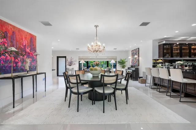 a view of a dining room with furniture and chandelier
