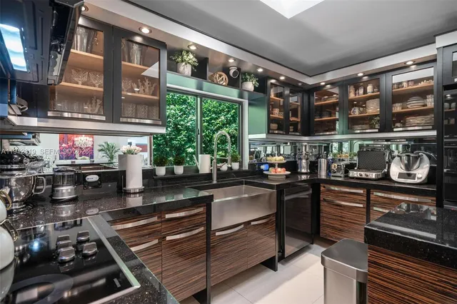 a kitchen area with stainless steel appliances granite countertop a stove and cabinets