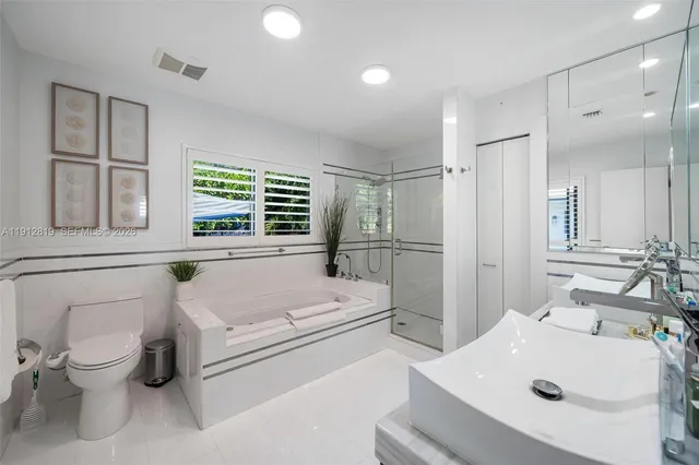 a bathroom with a sink toilet tub and shower