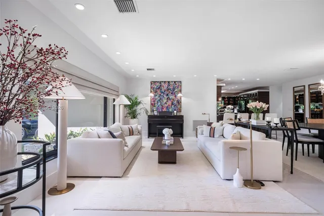 a living room with fireplace furniture and a chandelier