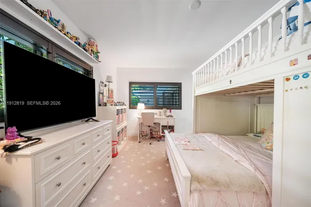 a bedroom with furniture and flat screen tv