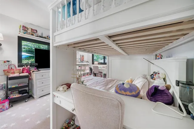 a bedroom with furniture and a large window