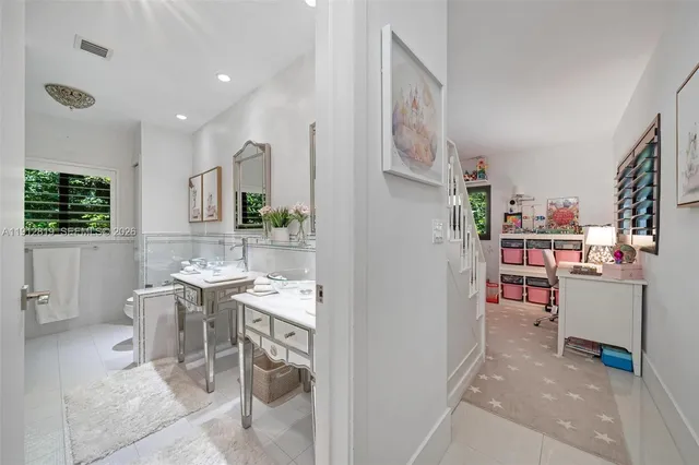 a bathroom with a tub sink and mirror