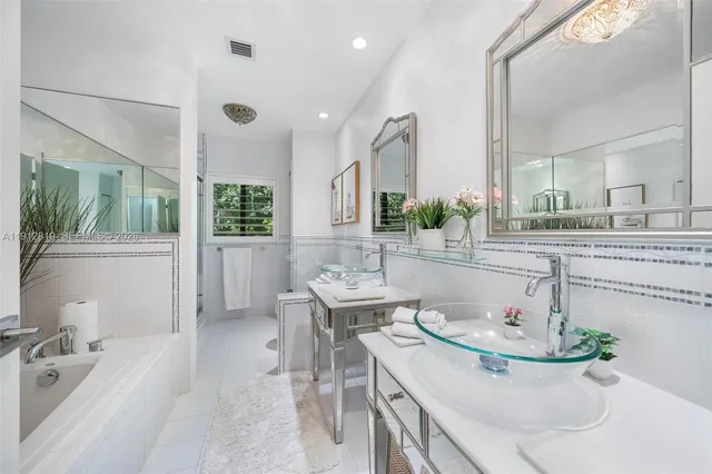 a bathroom with a double vanity sink a mirror and a shower