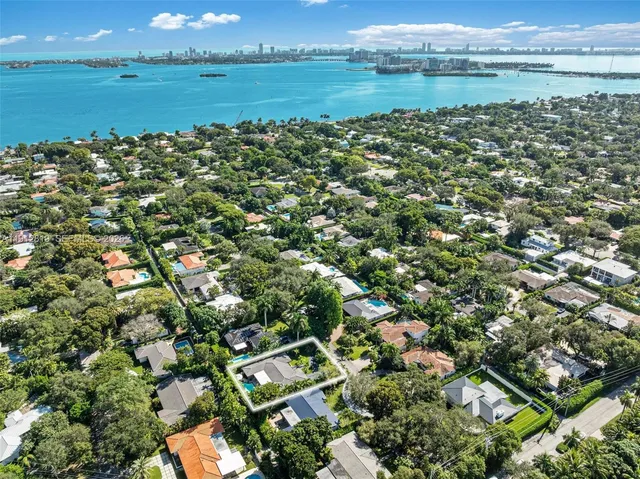 an aerial view of residential houses with outdoor and green space