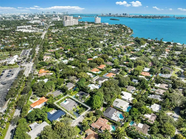 an aerial view of a houses with a yard