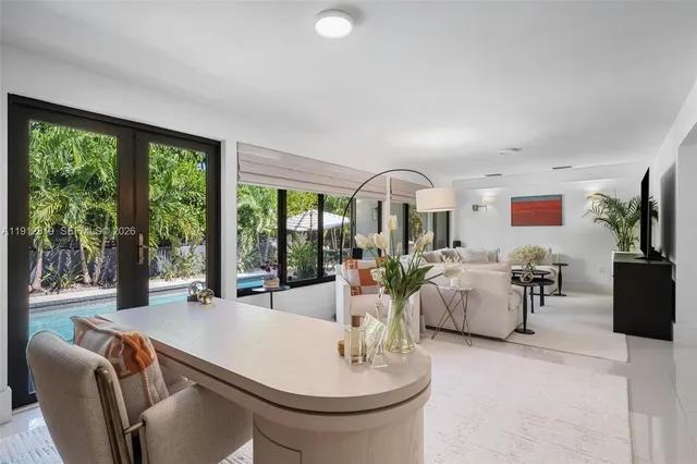 a living room with fireplace furniture and a large window