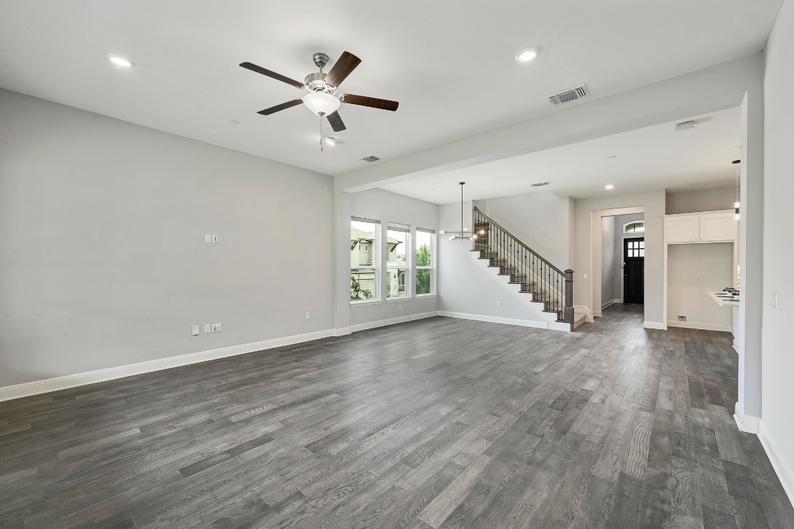 12308 Simmental Drive, Unit 94 Austin, TX 78732 - Photo 11 of 34 a view of an empty room with wooden floor and a ceiling fan