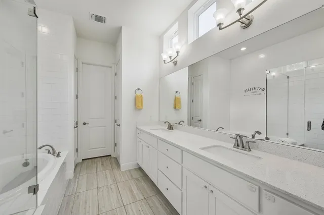 a spacious bathroom with a double vanity sink mirror and double