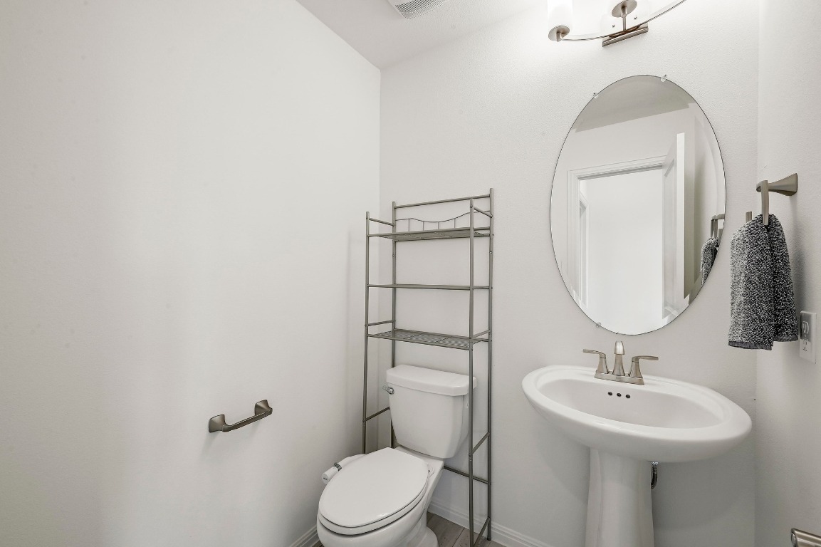 12308 Simmental Drive, Unit 94 Austin, TX 78732 - Photo 18 of 34 a bathroom with a sink toilet and a mirror