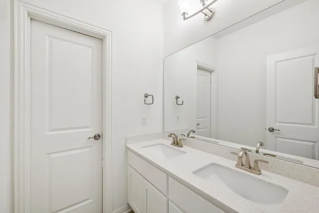 a bathroom with 2 sink and a mirror