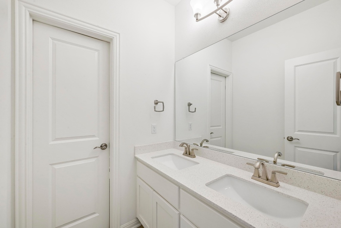 12308 Simmental Drive, Unit 94 Austin, TX 78732 - Photo 20 of 34 a bathroom with 2 sink and a mirror