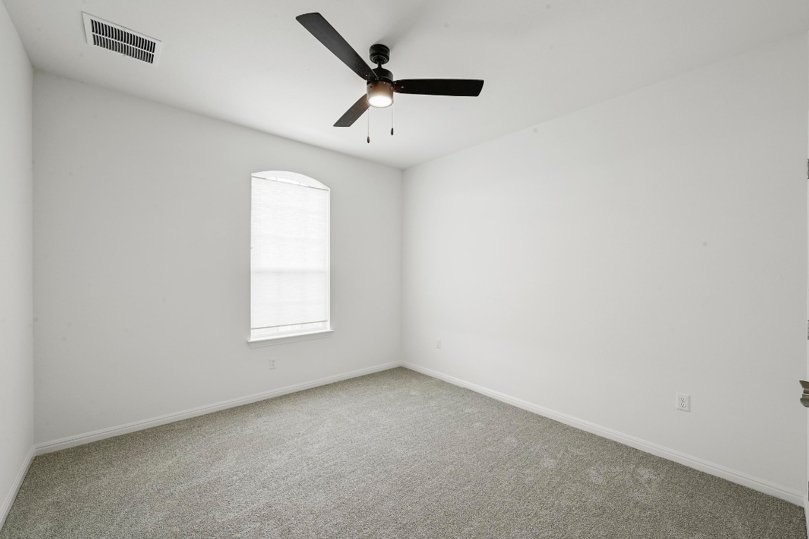 12308 Simmental Drive, Unit 94 Austin, TX 78732 - Photo 22 of 34 an empty room with a window and a ceiling fan