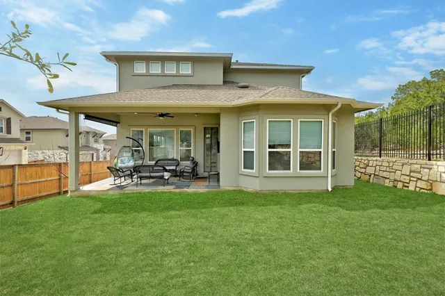 a view of a house with sitting area and garden