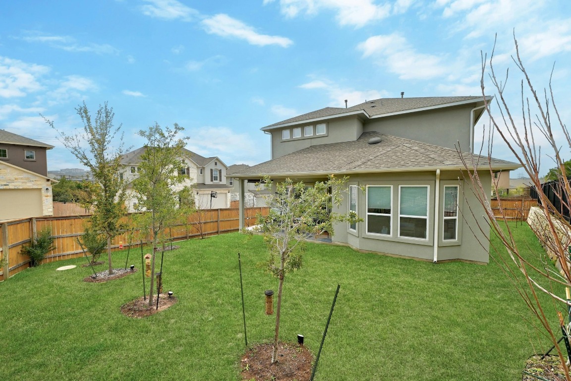 12308 Simmental Drive, Unit 94 Austin, TX 78732 - Photo 24 of 34 a view of a house with a yard