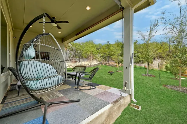 a view of a porch with a table chairs and wooden fence