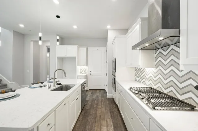 a kitchen with a sink stove and cabinets