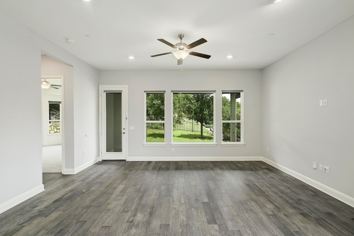 12308 Simmental Drive, Unit 94 Austin, TX 78732 - Photo 10 of 34 a view of an empty room with wooden floor and a window
