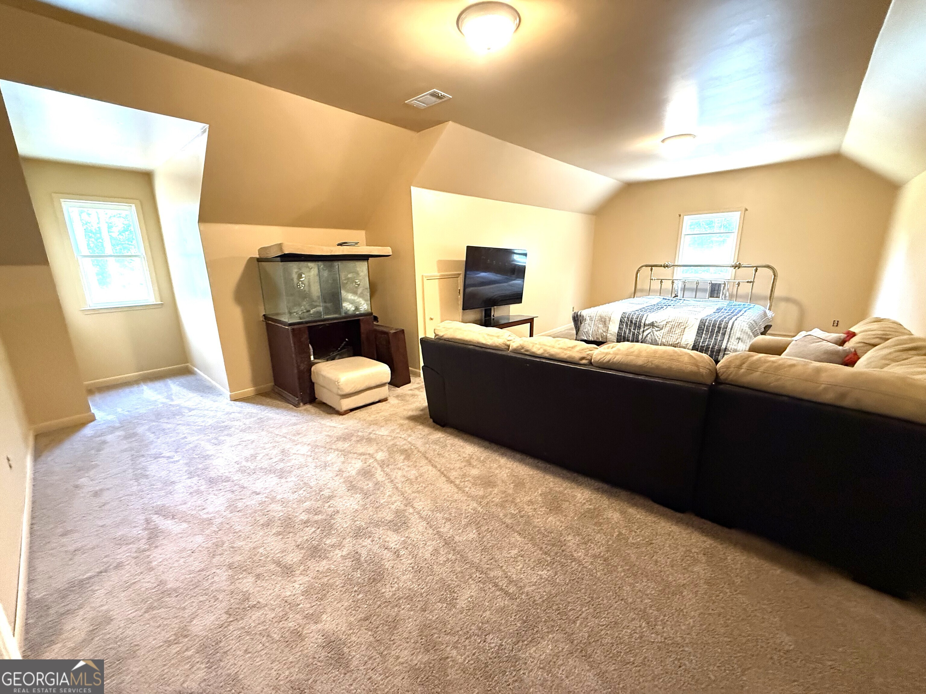 725 Musgrove Road Griffin, GA 30223 - Photo 38 of 52 a bedroom with furniture and a fireplace